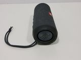 the jbl charger is plugged into the cord of the speaker