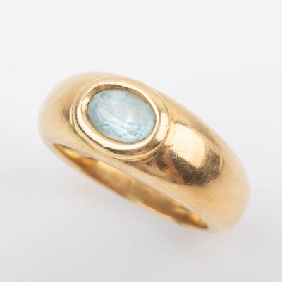 an image of a gold ring with a blue topaz stone