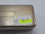 an antique silver cigarette case with a sticker on it