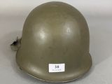 an army helmet with a tag on it sitting on a table