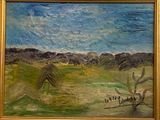 un tableau accroché au mur d'une pièce où se trouve un tableau représentant un paysage