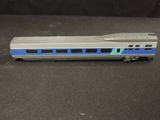 a silver and blue train car on a black surface
