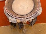 a dirty toilet with a bowl on top of it
