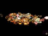 some very pretty colored diamonds on a black surface