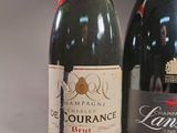 two bottles of champagne sitting next to each other on a table