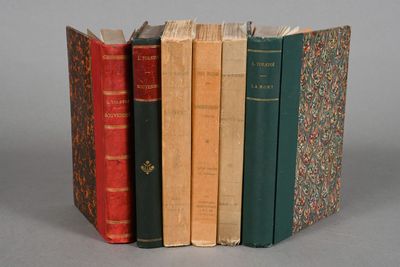 several old books are stacked on top of each other on a table