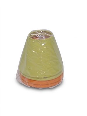 a plastic cone with a yellow top sitting on a white surface