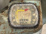 a close up of a rusty meter on the side of a building