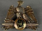 a bronze eagle on top of a ball with two wings