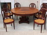 a wooden table with six chairs around it