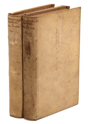 an old book sitting on top of a white surface