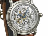 a close up of a watch with a brown leather strap