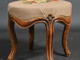 a small wooden stool with a floral design on it