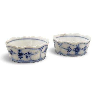 pair of blue and white porcelain bowls with floral designs on them