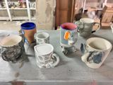 a lot of coffee cups sitting on a table