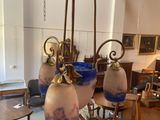 many vases hanging from the ceiling in this room
