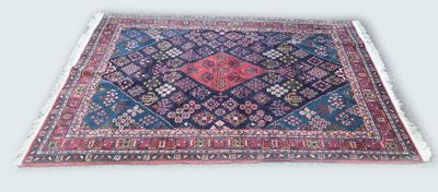 an oriental rug on a white background with a blue and red design