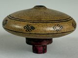 a brown and black object on a white surface