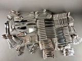 a lot of silver spoons and forks on the table