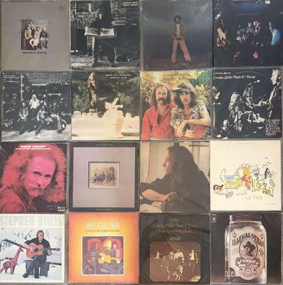 many different album covers on the wall of this room