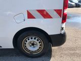 a white van with red and white stripes parked in a parking lot