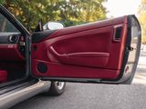 a red car with its door open on the street