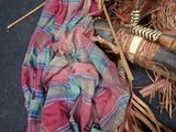 a doll that is sitting on the ground next to a basket