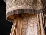 a bed with a canopy and a curtain on top of it