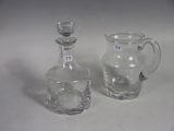 two small glass vases sitting next to each other on a table