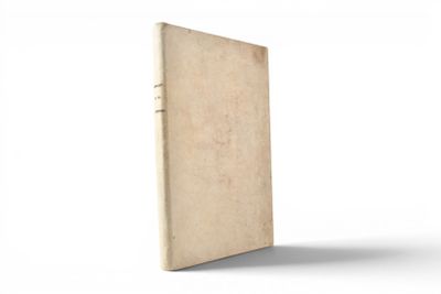 an old book sitting on top of a white table next to a white wall