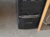 a black computer on a desk in a room