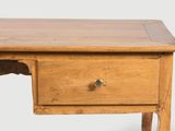 a small wooden desk with a drawer underneath it