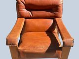 a brown recliner chair with a brown leather seat