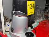 a silver blender sitting on top of a red counter