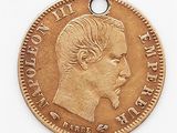 l'image d'une pièce d'or sur laquelle figure le visage d'un homme