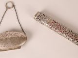 a silver purse and a silver purse hanging on a chain