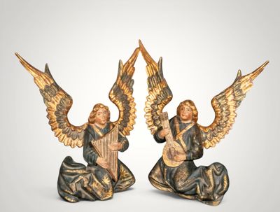 pair of angel figurines with musical instruments on a white background