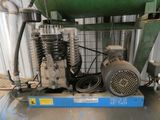 a small air compressor sitting on top of a table