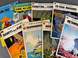 a lot of comic books that are on the table