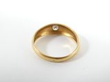 a close up of a gold ring with a diamond on it