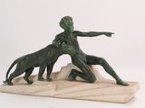 statue of a boy and a dog on a stone base