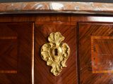 a close up of a wooden table with a gold plate on it