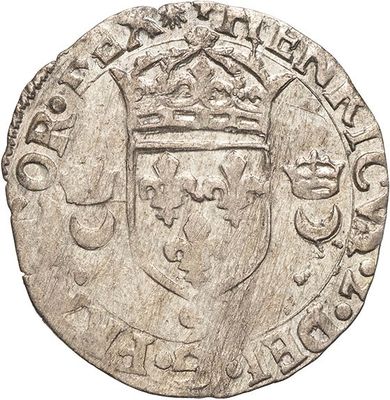 a close up of a silver coin with a crown on it