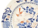 a blue and white plate with blue flowers and birds on it