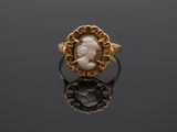 a gold ring with a cameo cameo of a woman in profile