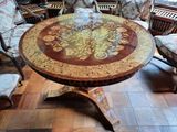 a table with a flower design on it in the middle of a room