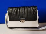 a black and white purse sitting on top of a white table
