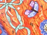 a picture of a painting of flowers and butterflies on a red background