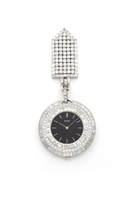 a close up of a watch on a white surface with diamonds
