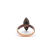 a close up of a ring with a black diamond on it
